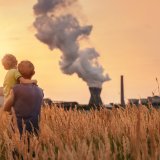 adobestock_64551301_power_plant_child_man_field_sunny_environment_co2